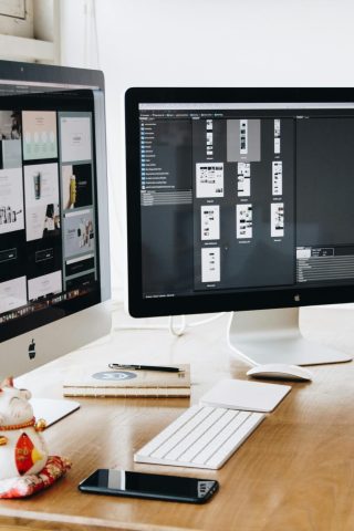 pexels-photo-326503-326503 A well-organized design workspace with dual monitors and design software on display.